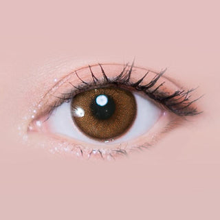 Macro shot of an eye wearing the i-Sha Melo Art Almond Brown prescription colour contact lens, showing the multi-colored detail and natural effect on dark brown eyes.