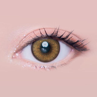 Macro shot of an eye wearing the i-Sha Melo Art Pine Brown prescription colour contact lens, showing the multi-colored detail and natural effect on dark brown eyes.