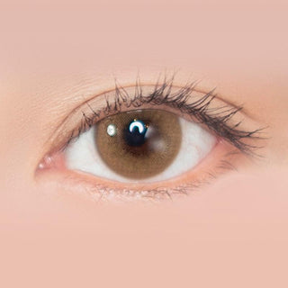 Macro shot of an eye wearing the i-Sha Shine Smile Butter Muffin Brown prescription colour contact lens, showing the multi-colored detail and natural effect on dark brown eyes.
