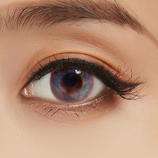 Close up of Prism Blue Color Contact Lens for Dark Eyes, with minimal eye makeup, showing the iridescent color of the lens design.