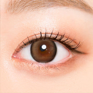 Macro shot of an eye wearing the i-Sha Oriana Mune 1-Day Brown (10pk) prescription colour contact lens, showing the multi-colored detail and natural effect on dark brown eyes.