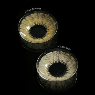 Macro shot of the Milan Grey and Brown prescription colored contact lenses on a dark background, showing the detailed pattern of the contact lens design