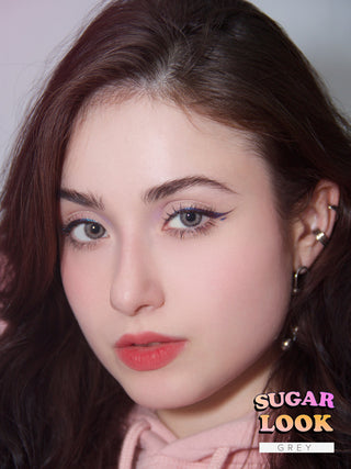 Model showcasing EyeCandys Sugarlook Grey colored eye lenses with complementary pink lipstick